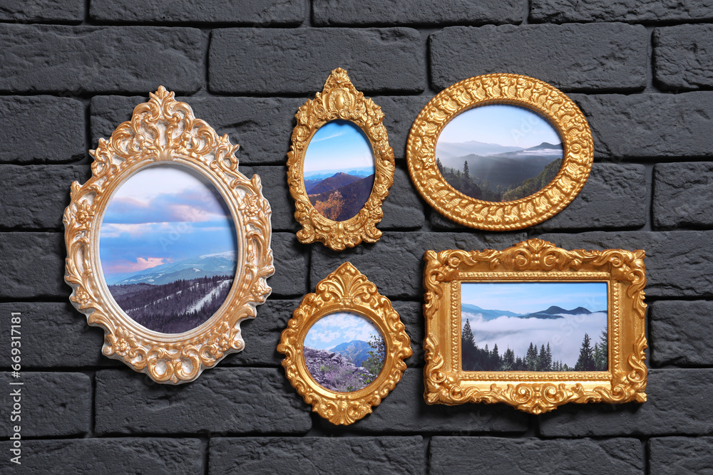 Vintage frames with photos of beautiful landscapes hanging on dark brick wall