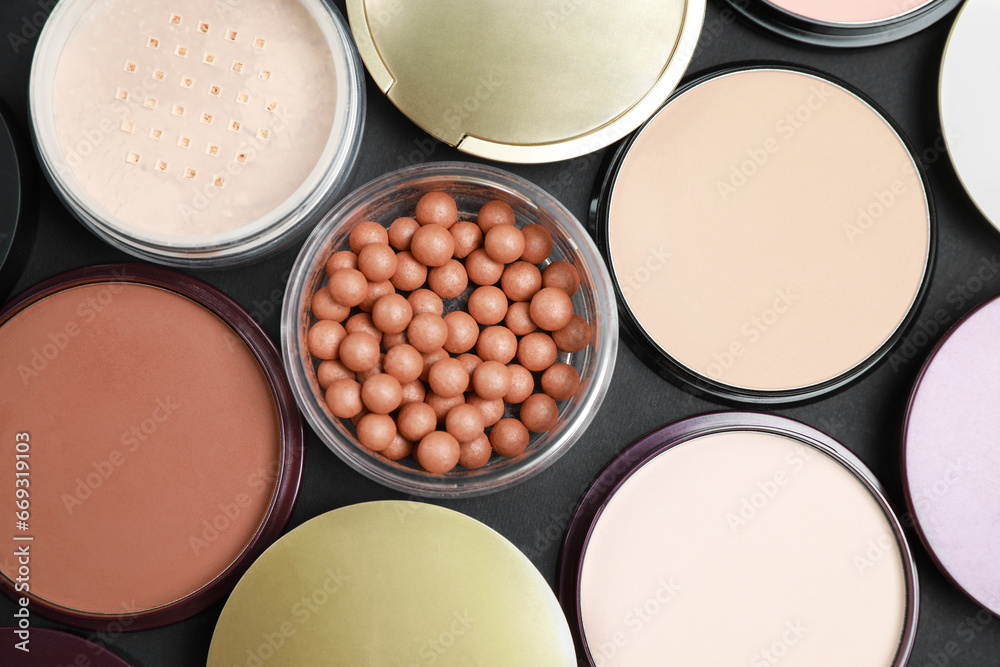 Different face powders on black table, flat lay Different face powders on black table, flat lay
