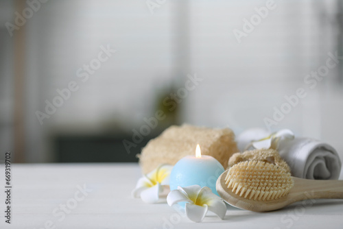 Composition with different spa supplies and flowers on white wooden table indoors, space for text