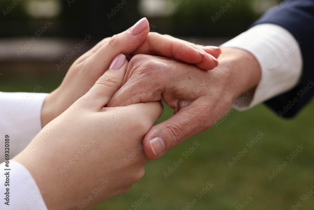Trust and deal. Partners joining hands outdoors, closeup
