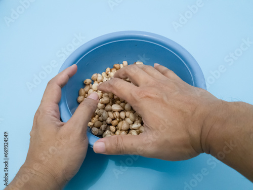 Peanuts that have been peeled from the skin in a blue container