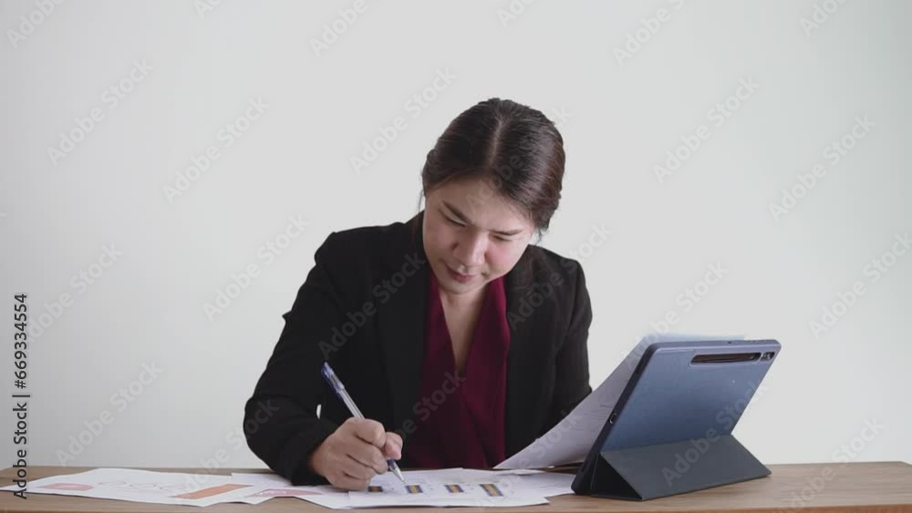 Asian woman working with digital tablet and paperworks, Successful professional woman working. Asian woman working with digital tablet and paperworks, Successful professional woman working.