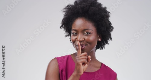 Secret, woman and silence or mystery by finger, privacy and confidential information in studio. Gossip, drama and whisper emoji, shush and quiet for black female model by white background in mockup photo