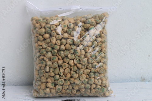 Indonesian snack called kacang polong goreng tepung made from peas in plastic on table photo