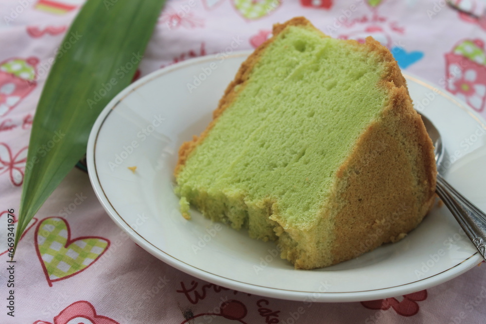 A piece of pandan cake in a plate on a table A piece of pandan cake in a plate on a table