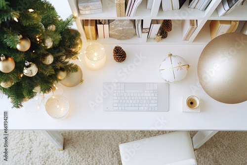 a christmas tree with gold ornaments on it and a computer keyboard in the fore - image is taken from above