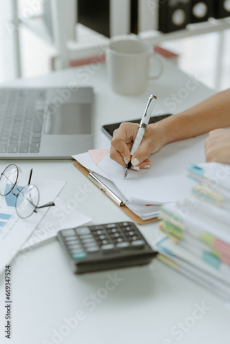 Obraz na plátně Businessman man working in stacks of papers searching for unfinished paperwork i