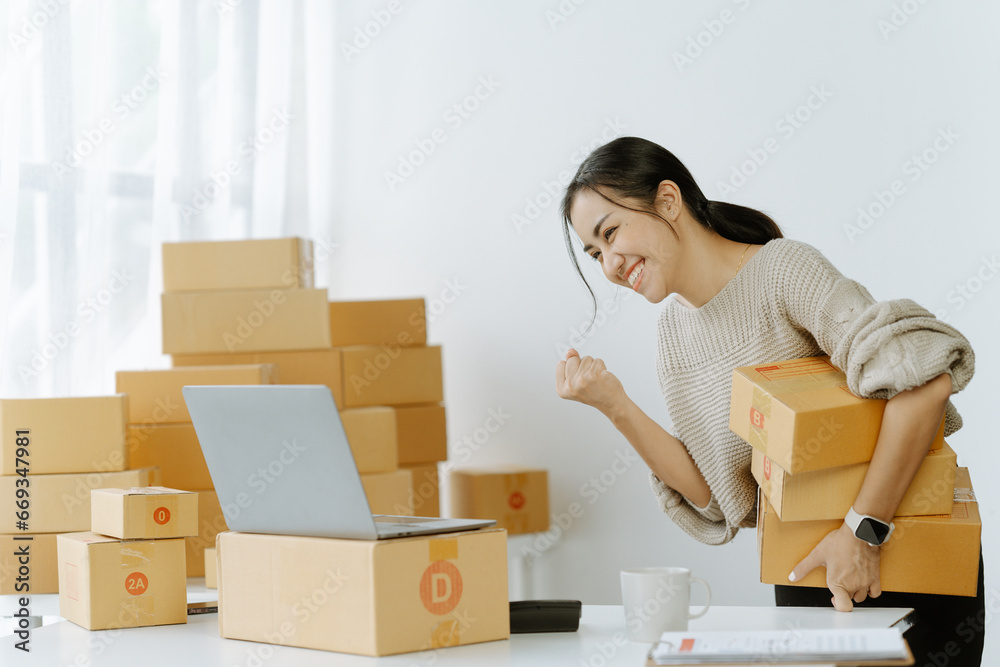 ortrait of a small business startup, SME owner, female entrepreneur, working, unboxing, checking orders online. To prepare to pack boxes for sale to SME customers online business ideas ortrait of a small business startup, SME owner, female entrepreneur, working, unboxing, checking orders online. To prepare to pack boxes for sale to SME customers online business ideas
