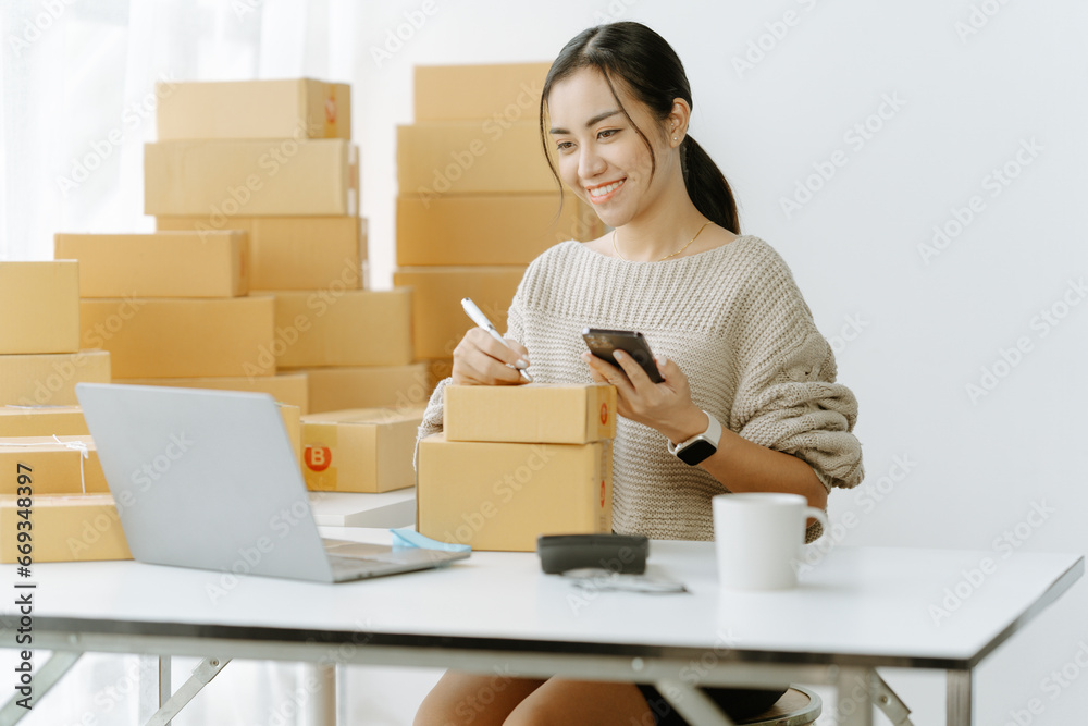 Small start-up business owners checking parcels at work, salespeople, checking production orders. Pack products for delivery to customers Sell Ecommerce Shipping Ideas Small start-up business owners checking parcels at work, salespeople, checking production orders. Pack products for delivery to customers Sell Ecommerce Shipping Ideas