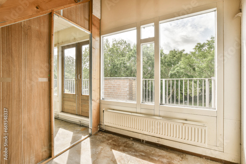 an empty room with wooden walls and white trim around the window panes, which are being used for construction work