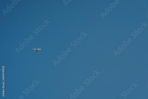 Passenger plane flies in the clear blue sky