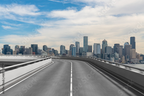 Empty urban asphalt road exterior with city buildings background. New modern highway concrete construction. Concept way to success. Transportation logistic industry fast delivery. Seattle. USA.