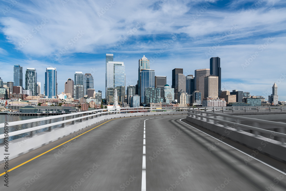 Empty urban asphalt road exterior with city buildings background. New modern highway concrete construction. Concept way to success. Transportation logistic industry fast delivery. Seattle. USA. Empty urban asphalt road exterior with city buildings background. New modern highway concrete construction. Concept way to success. Transportation logistic industry fast delivery. Seattle. USA.