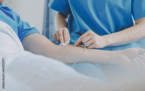 Women Asian doctors hold the patient hand and encourage and provide medical advice While checking the patient health in bed. Concept of Care and compassion, antenatal care, Threatened abortion