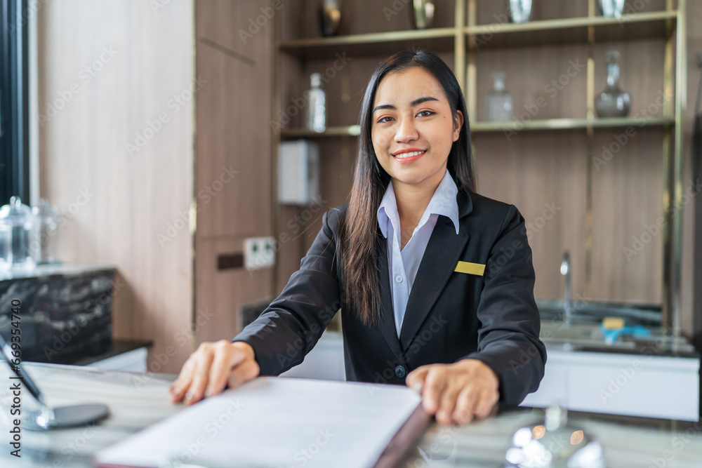 Beautiful asian hotel receptionist in uniforms at desk in lobby Friendly and welcome staff in hotel reception counter. Beautiful asian hotel receptionist in uniforms at desk in lobby Friendly and welcome staff in hotel reception counter.