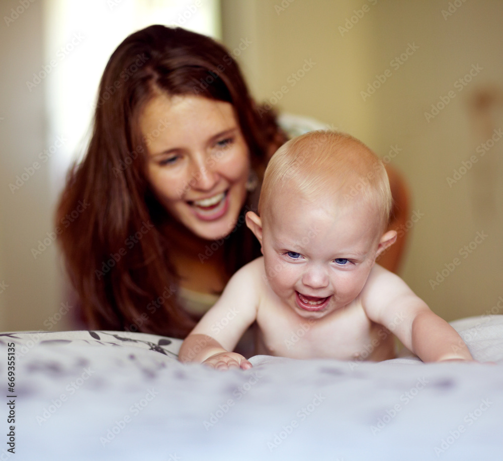 Laughing, playing and a mother with a baby on the bed for bonding, love and care in the morning. Wake up, smile and a mom with a kid or family together in the bedroom of a house for happiness Laughing, playing and a mother with a baby on the bed for bonding, love and care in the morning. Wake up, smile and a mom with a kid or family together in the bedroom of a house for happiness