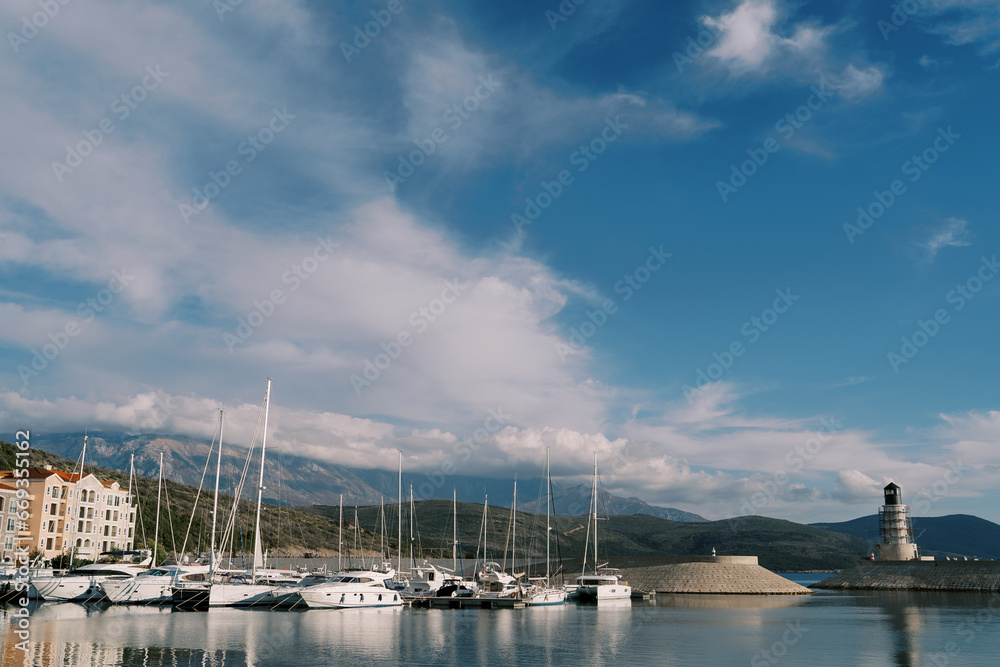 Row of sailing yachts are moored at Lustica Bay near the lighthouse. Montenegro