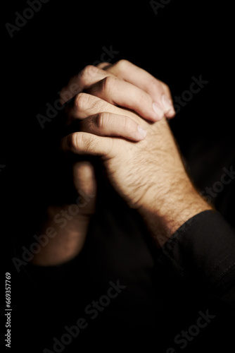 Praying, hands and black background for faith, hope and religion or asking for help with mental health or support in studio. Prayer emoji, christian person and sorry, forgive or humanity in dark room
