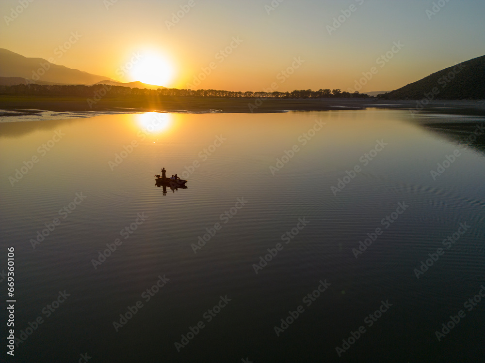 Fototapeta premium Bursa Golbasi Dam: Dreamy Views at Sunset,Turkey.Place Decorated with Fishing Boat and Dried Trees.