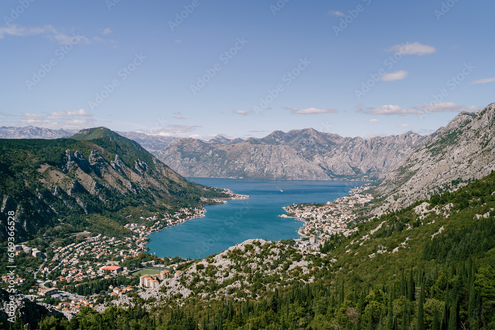 Valley of the Bay of Kotor surrounded by high mountains in bright sunlight. Montenegro