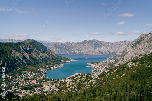 Valley of the Bay of Kotor surrounded by high mountains in bright sunlight. Montenegro