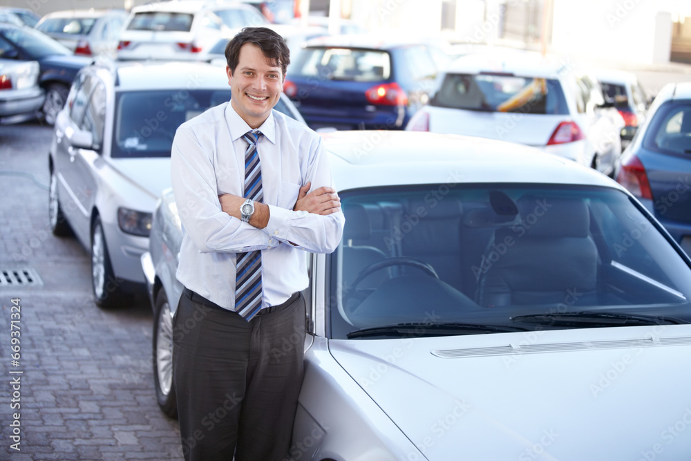 Portrait, luxury and a man arms crossed at a dealership for car sale in a commercial parking lot. Business, smile and automobile trade with a happy young salesman outdoor for transport service Portrait, luxury and a man arms crossed at a dealership for car sale in a commercial parking lot. Business, smile and automobile trade with a happy young salesman outdoor for transport service