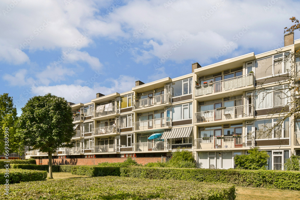 an apartment complex with trees and bushes in the fore - swayr, vancouver, british columbia region, canada