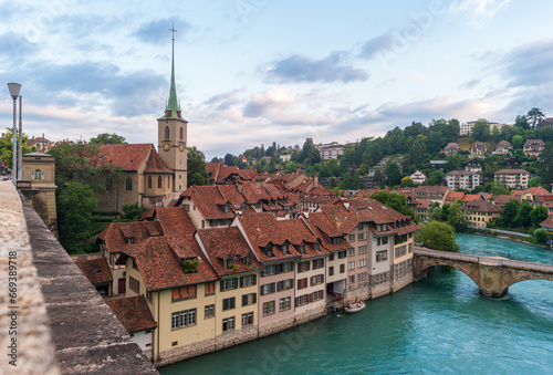 Bern, Switzerland. Cityscape with Nydeggkirche church and Untertorbrucke bridge over Aare river in early morning.