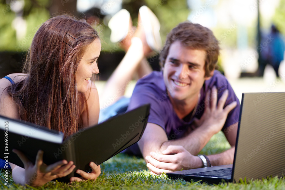 Students, outdoor and laptop on grass, university and smile for workbook, learning and technology. College, notebook and teenager for education, career or studying together for exam, man and woman