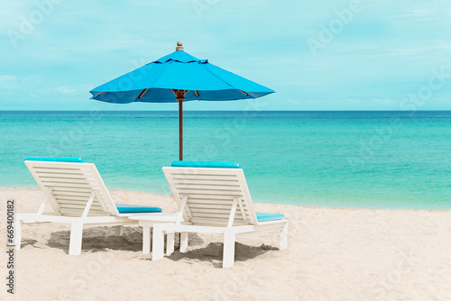 Beautiful blue sun loungers on the shore of a paradise island