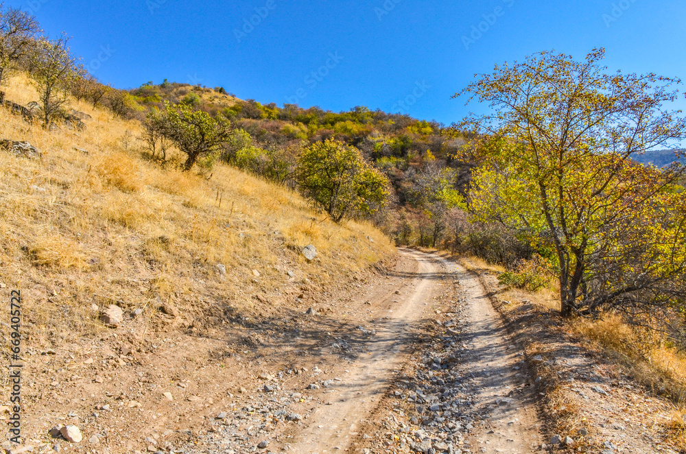 dirt road in the mountains of Kungurbuka ridge near Karankul village (Tashkent region, Uzbekistan)