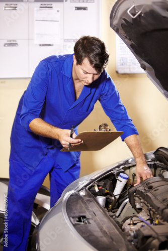 Checklist, man and mechanic check engine of car, repair or maintenance. Clipboard, technician and serious person on motor vehicle, fixing transport or reading inspection list at auto service workshop