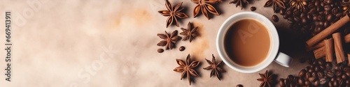 Cup of hot coffee surrounded by anise stars, coffee beans on a warm-toned textured background. Christmas and New Year. Suitable for winter promotions, café menus, banner with free space for text