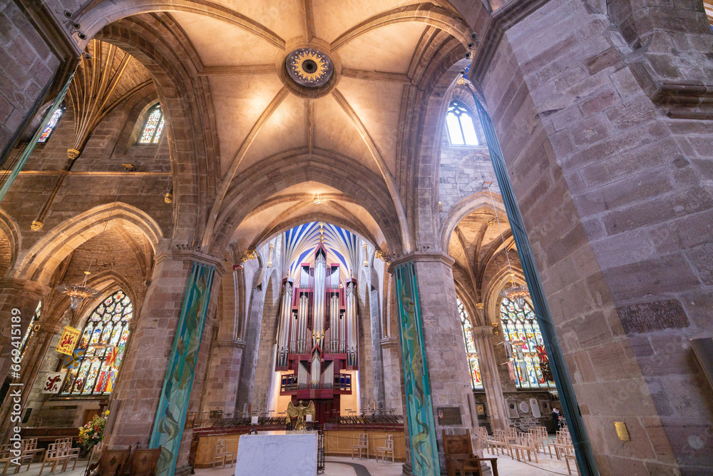 Edinburgh a majestic cathedral adorned with vibrant stained glass windows and rows of seating