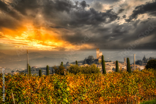 the castle of serralunga d'alba in the midst of the vineyards and hills of the Piedmontese Langhe, in the autumn of 2023 during the truffle and grape harvest festival photo