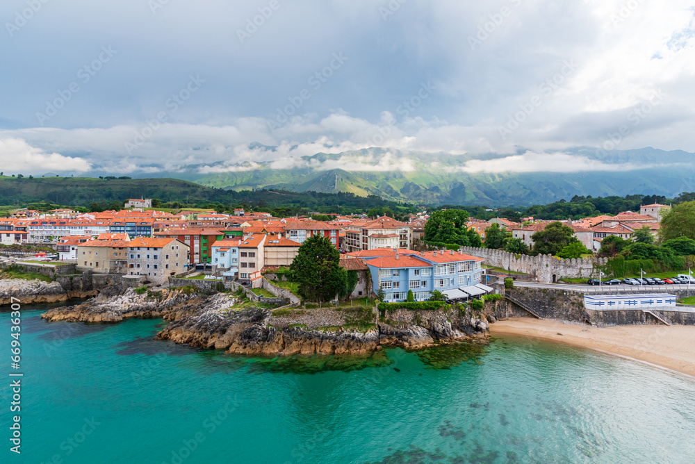 Sablon beach and the city of Llanes with the Cantabrian mountain range in the background, Asturias.