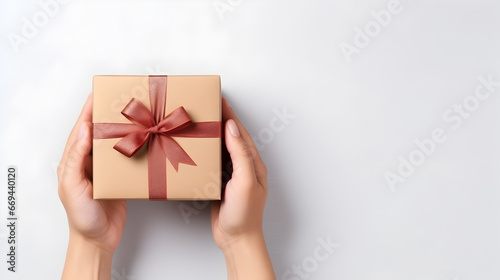 Hand holding a New Year's gift box on a white background.