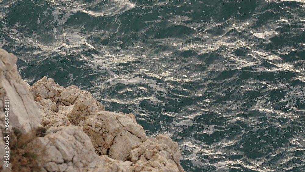 sea waves crushing over rocks with soft light