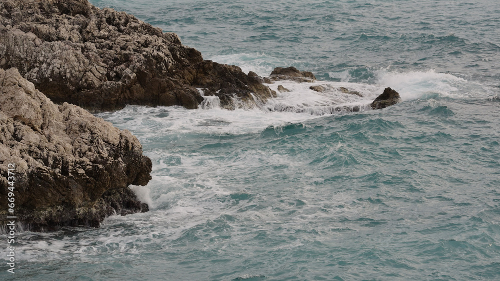 sea waves crushing over rocks with soft light sea waves crushing over rocks with soft light