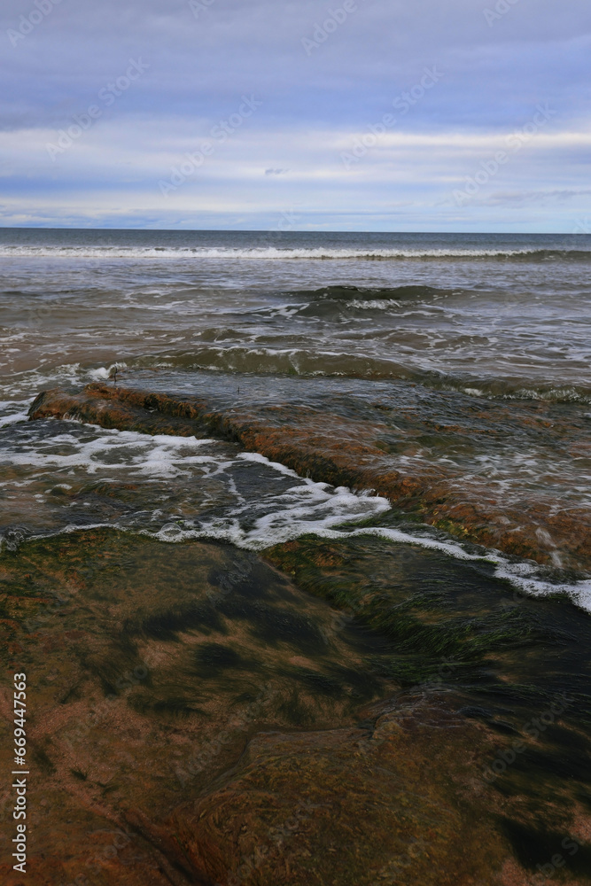 Rocks, waves and sky