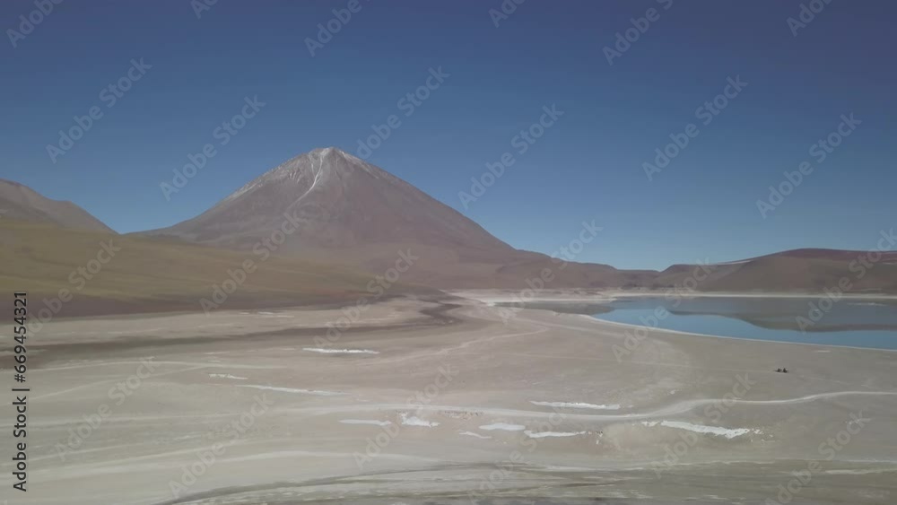aerial drone shot of the laguna verde and blanca in the arid landscape near volcano Licancabur in the high altitude of the Andes mountains in the highlands of Bolivia. aerial drone shot of the laguna verde and blanca in the arid landscape near volcano Licancabur in the high altitude of the Andes mountains in the highlands of Bolivia.