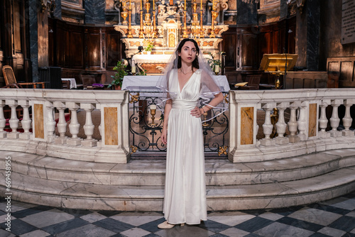 Wallpaper Mural Young woman in white dress in a catholic church Torontodigital.ca