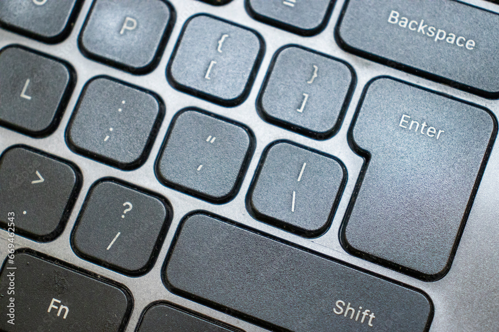 Closeup shot of a black laptop keyboard in use. Closeup shot of a black laptop keyboard in use.