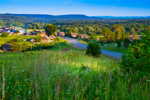 summer landscape with a view from the hill to the village and the road