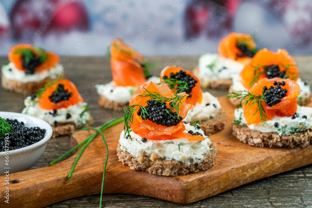Cocktail canapes with smoked salmon, cream cheese and caviar on rye bread - gourmet party food. - obrazy, fototapety, plakaty 