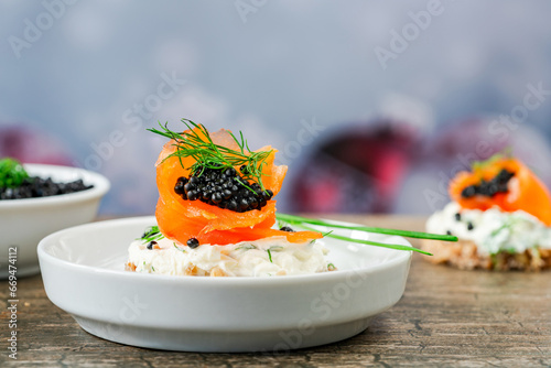 Canvas Print Cocktail canapes with smoked salmon, cream cheese and caviar on rye bread - gourmet party food