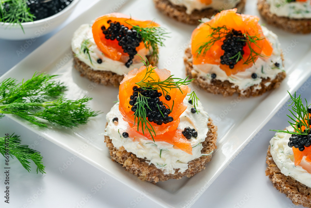 Cocktail canapes with smoked salmon, cream cheese and caviar on rye bread - gourmet party food. Cocktail canapes with smoked salmon, cream cheese and caviar on rye bread - gourmet party food.