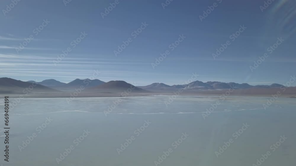 aerial drone shot of the laguna verde and blanca in the arid landscape near volcano Licancabur in the high altitude of the Andes mountains in the highlands of Bolivia. aerial drone shot of the laguna verde and blanca in the arid landscape near volcano Licancabur in the high altitude of the Andes mountains in the highlands of Bolivia.