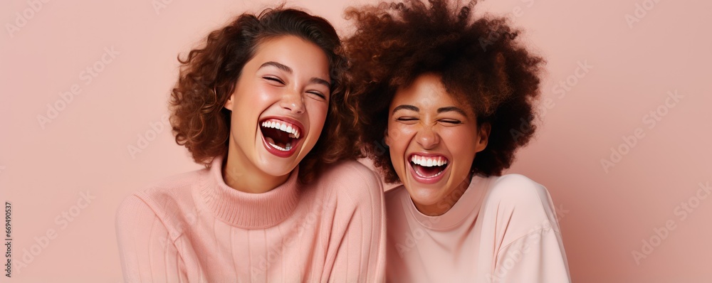 African American and Caucasian girlfriends laugh cheerfully while taking a photo together. Cheerful best friends laugh together posing for photo. Young women of different races support each other - obrazy, fototapety, plakaty 