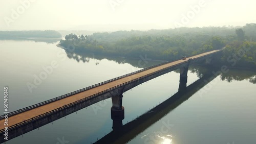 Aerial view of a Motor Bridge connecting the island of Tarkarli, Maharashtra, India surrounded by coconut trees. photo